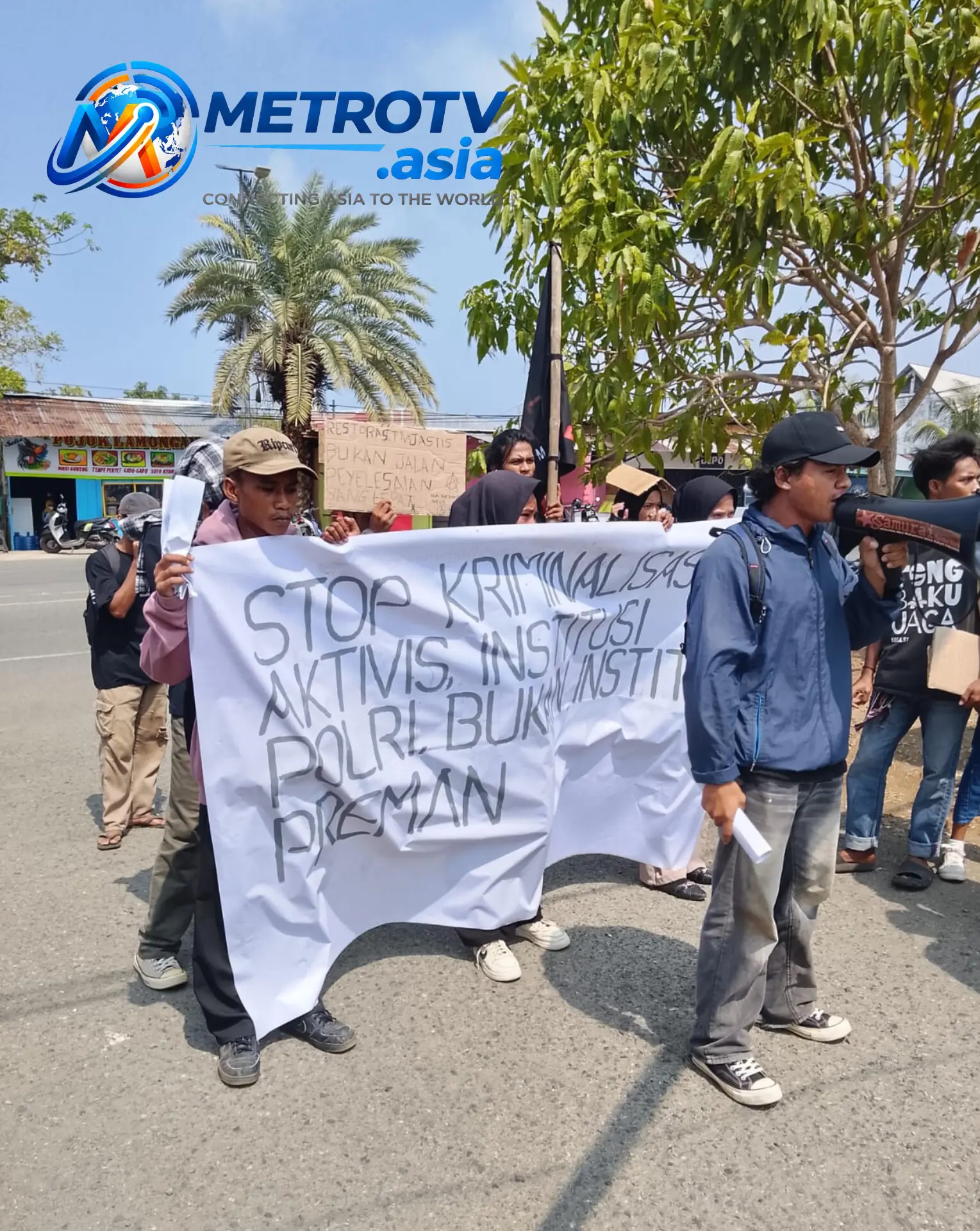 Mahasiswa SAMURAI-MU UNIPAS menggelar aksi unjuk rasa di Morotai, membentangkan spanduk besar bertuliskan "Stop Kriminalisasi Aktivis, Polri Bukan Institusi Preman"